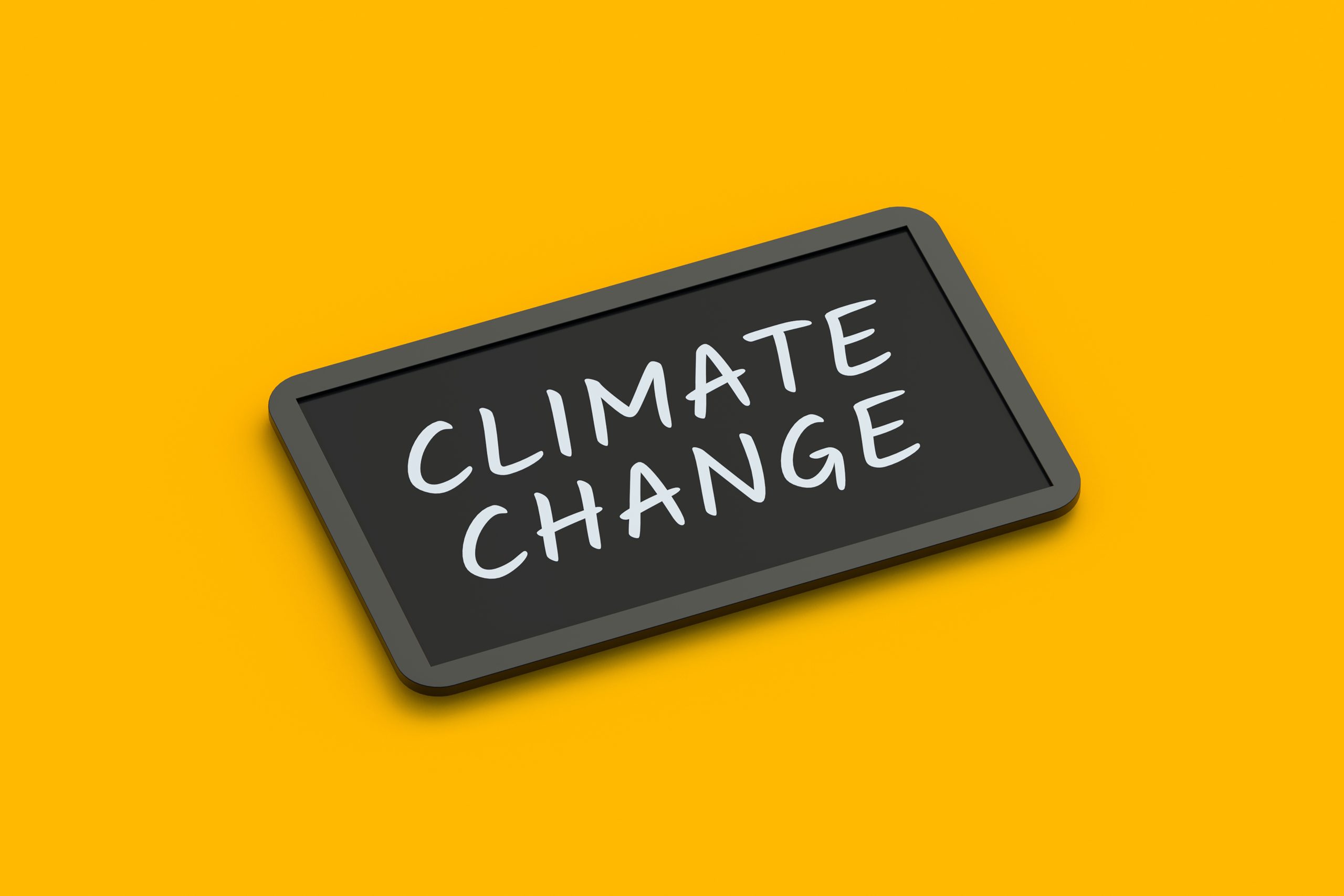 Climate Change words on a chalk baord with yellow backgrou